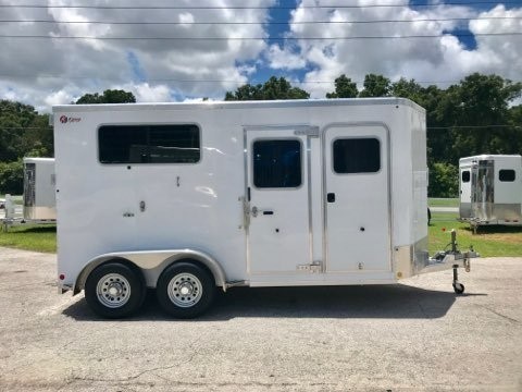 (On Order) 2022 Kiefer (2) horse straight load bumper pull trailer with a tack room that is completely insulated and lined, saddle racks, bridle hooks and a camper door! The horse area has an interior height at 7’6” tall x 7’2” wide x 16’ long, (2) escape doors, (2) drop down windows with drop down aluminum bars, removable divider, rubber mats over all aluminum floor and a rear ramp with dutch doors! The exterior has two 3500lbs and a spare tire. 8 Year Warranty – Weighs 3500lbs.