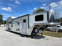 2022 Cimarron (3) horse slant load side load living quarter trailer with  a 15’9” Outback Customs Conversion that has a bed over the nose, stairway access on each side of the bed, A/C unit, furnace, slide out with a couch that folds into a bed and a 6cu fridge & freezer, corner chair on the left as you enter the living room, T.V. and radio centered over the bedroom, convection oven microwave, sink, cooktop, cabinets and large closet space.   