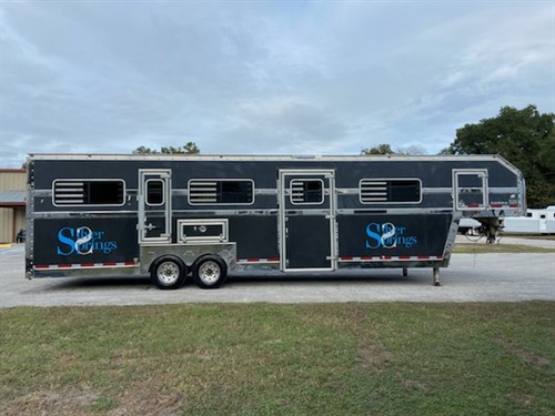 2005 Pegasus (8) horse head to head trailer with storage over the nose, closes off completely from the horse compartment.  The interior height is 8’ tall x 8’ wide, escape door, large sliding bus windows along the sides of each horse, side ramp with dutch door,  storage over the wheel wells, two access doors to rear compartment, AIR RIDE EQUIPPED. 