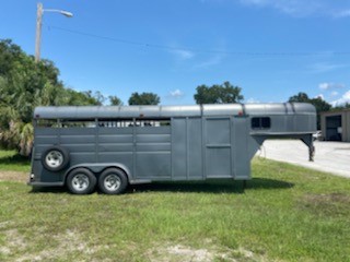 2002 Longhorn (4) horse slant load stock combo trailer with a front tack room that has saddle racks and bridle hooks.   The horse area has an interior height at 7' tall x 7' wide, stock sided, rubber mats over wood floor and a full swinging rear door.  Spare tire. 