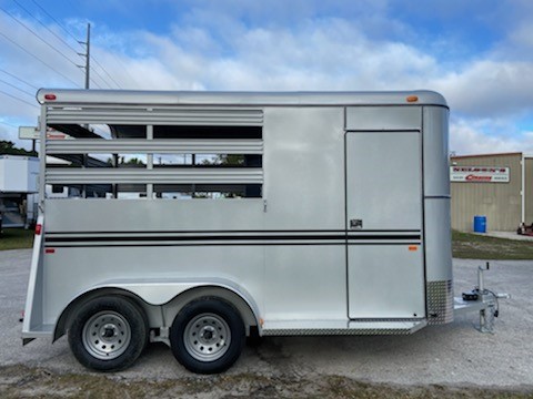 (ON ORDER) 2022 Bee (2) horse slant load bumper pull trailer with a front tack room that has removable saddle racks, bridle hooks and a swinging tack room wall.  The horse area has an interior height at 7’6” tall x 6’8” wide, escape door, padded dividers, rubber lined walls, rubber mats over wood floor and a full swinging rear door.  The exterior has two 3500lbs axles and a spare tire.   Silver in color.  