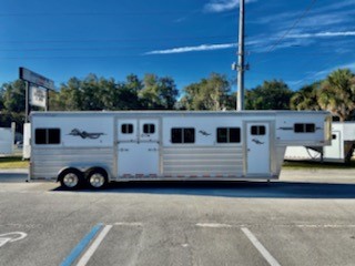 2014 Platinum Coach (4) horse head-to-head trailer with a 4’ front tack room that has saddle racks, bridle hooks and a brush box.  The horse area has an interior height at 8’ tall x 7’ wide, escape door with a drop-down window, side ramp with dutch doors, removable dividers, rubber mats over all aluminum floor and a rear ramp with dutch doors.   Spare tire.   