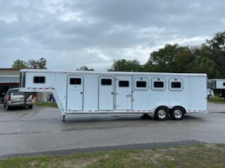 2002 Exiss Event MT 400 (4) horse slant load gooseneck trailer with a 4' tack room that has a walk thru door into the Midtack.  In the Midtack you have bridle hooks, area for a saddle rack and another walk thru door into the horse area.  In the horse area you have an interior height at 7' tall x 7' wide, escape door, drop down windows at the horses heads, sliding bus windows at the horses hips, roof vents, rubber lined walls, rubber mats over all aluminum floor, 