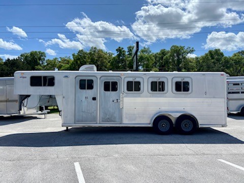 2000 Sooner (4) horse slant load living quarter with a 4’ conversions that has an A/C unit, microwave, sink, insta-hot water heater, small closet with extra storage bins, shower/toilet combo, cabinets and a walk thru door into the horse area.