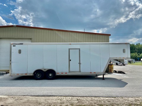 2004 Cimarron 24’ cargo gooseneck trailer with an interior height at 8’6” tall x 8’ wide x 24’ long, curbside escape door, insulated roof, double back rear doors, two 8000lbs axles, electric over hydraulic brakes, and a spare tire.   