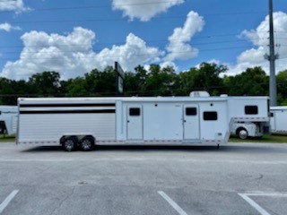 2022 Kiefer 14’ Stock Living Quarter Trailer with a 10’ LSR Conversion that has an A/C unit, furnace, dinette, microwave, sink, cooktop, 6cu & freezer, closet, cabinets, T.V. and stereo system.   The bathroom has a toilet, radius shower, sink with medicine cabinet, linen closet and a walk thru door 