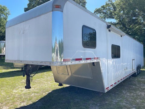 2014 Vintage 14’ Living Quarter Enclosed Trailer equipped with an A/C unit, furnace, Slide Out with a couch, microwave, 6cu fridge & freezer, lots of cabinets, large closet, spacious counter tops, T.V. and a large bathroom.   In the bathroom you have a toilet, shower, sink with medicine cabinet and a walk thru door into the enclosed area.   As you walk thru you have an L-Shape countertop, access door on the curbside and French doors at the rear with a rear ramp. 