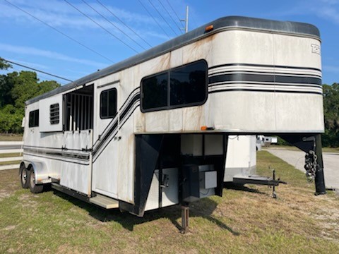 2007 Trailet (2+1) Trailer with a 4’ tack room that has saddle racks, bridle hooks and a brush box.  The horse area has an interior height at 7’6” tall x 7’ wide, roof vents, escape door, side ramp with dutch doors, air flow center gates, rubber mats over wood floor, and a rear ramp with dutch doors.   Spare tire.  